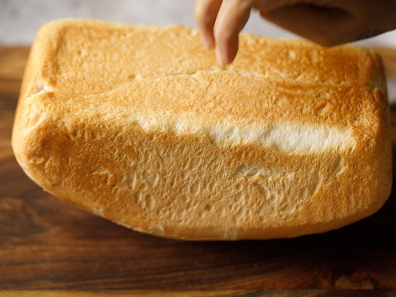 tapping the bread loaf