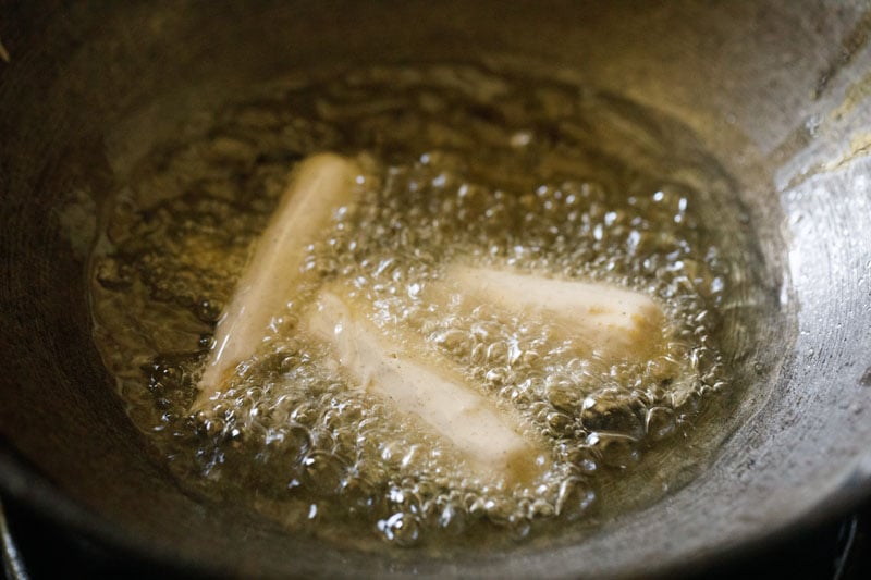 batter-coated baby corn pieces in hot oil