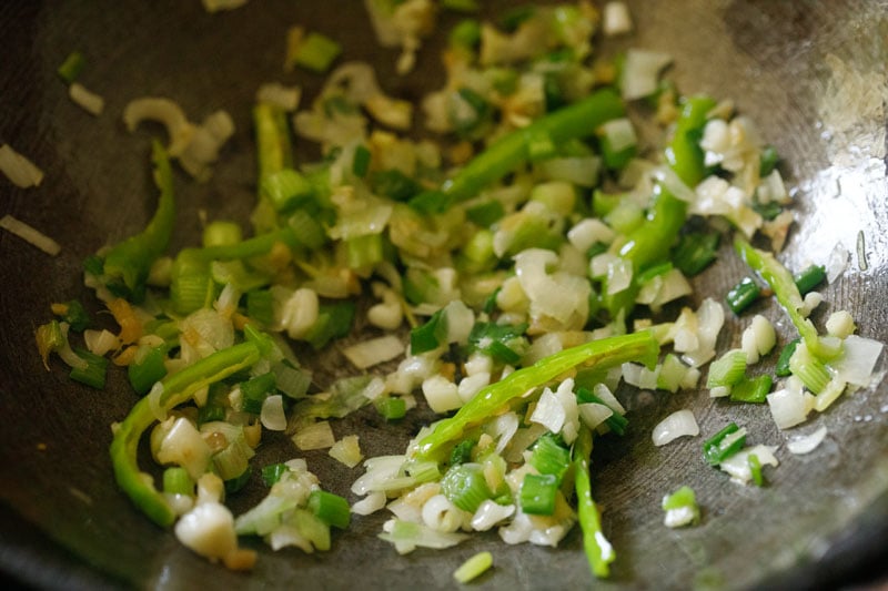 stir frying aromatics in a wok