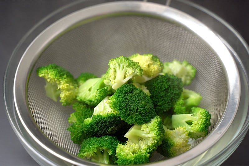 top shot of broccoli on strainer