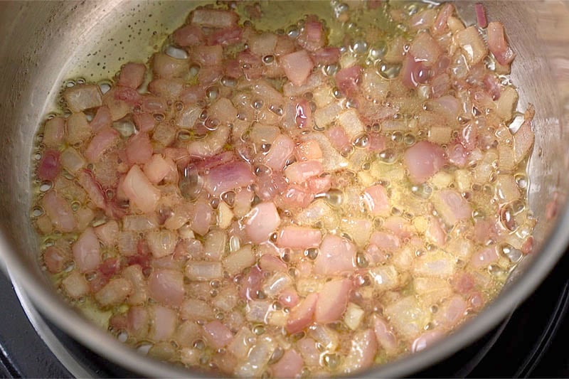 top shot of onions softened in a pot