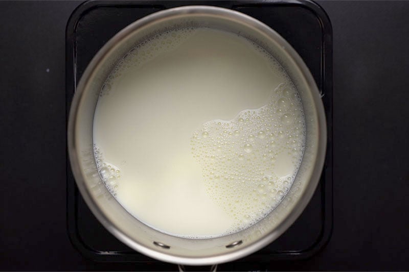 top shot of milk heating in pot