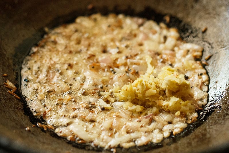 ginger-garlic paste added to sautéed onions in a kadai