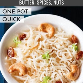 ghee rice topped with fried cashews, raisins, coriander leaves in a white bowl