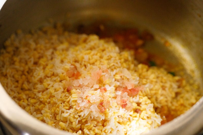 pink salt crystals on rice and lentils in pressure cooker