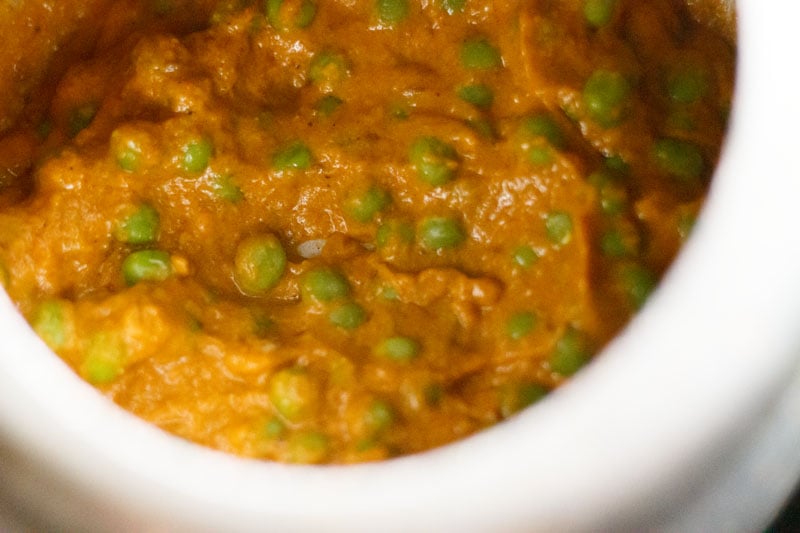 Top shot of green peas mixed into masala paste