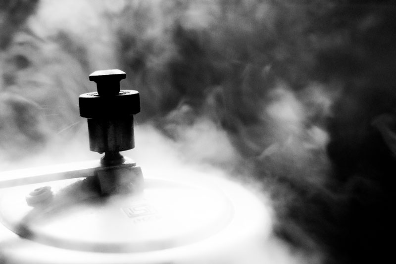 Top shot of pressure cooker with lid with steam around it