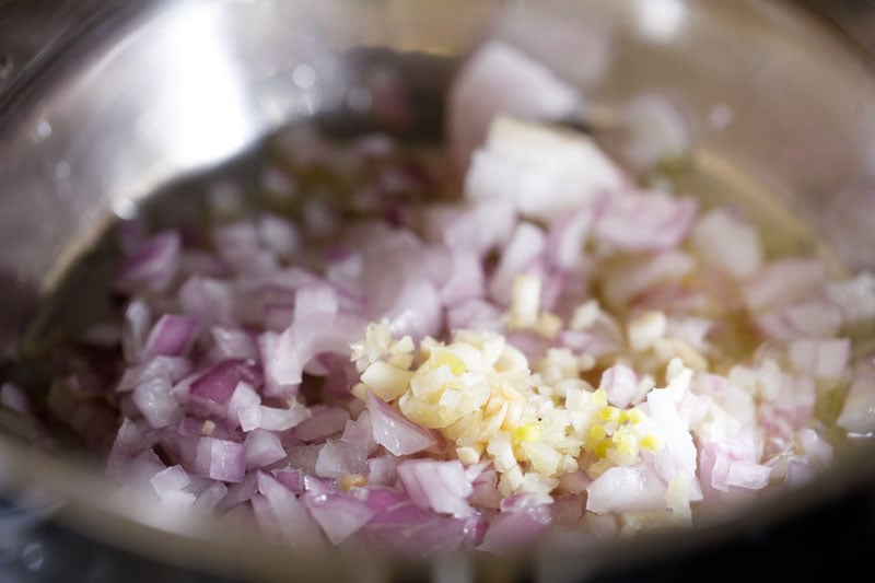 chopped onions and garlic in a steel pan