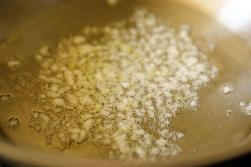 minced garlic sautéing in a skillet with oil