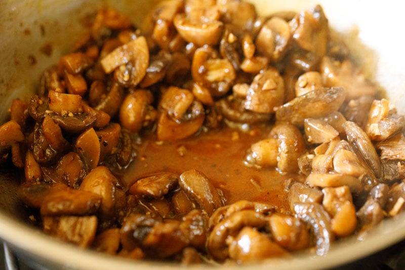 liquid from the mushrooms beginning to evaporate, but still coating the bottom of the pan