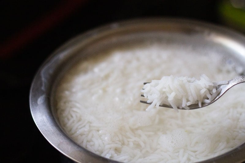 rice grains cooked al dente shown in a fork