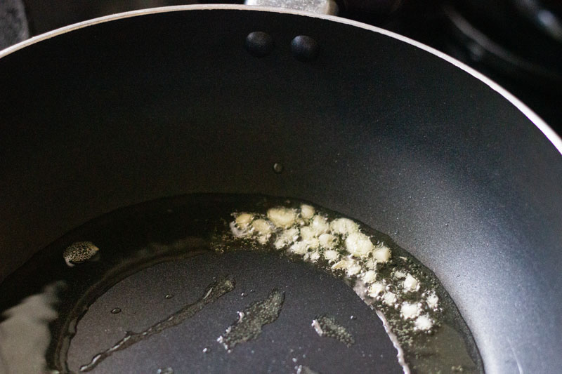 garlic being sautéed in oil