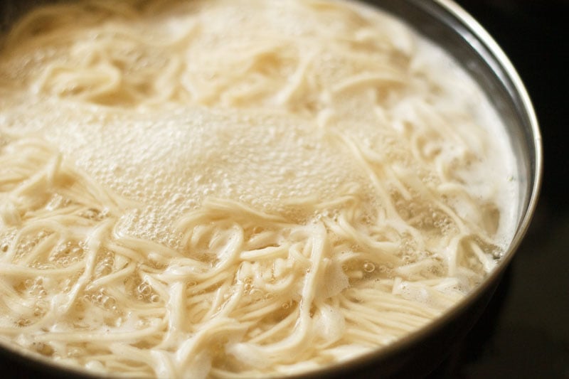 cooking noodles in bubbling hot water