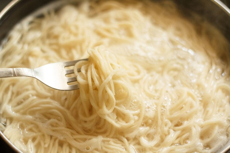 some cooked noodles lifted with a silver fork