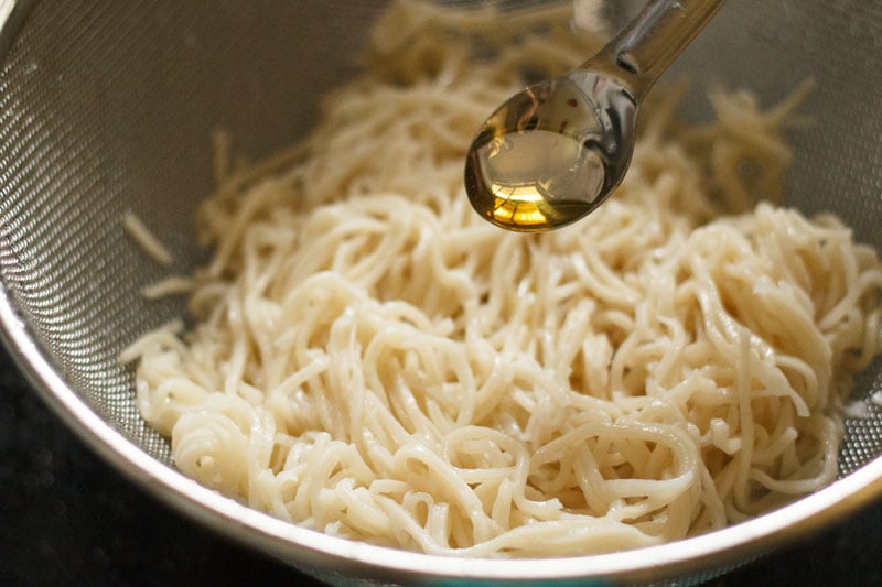 adding oil to noodles
