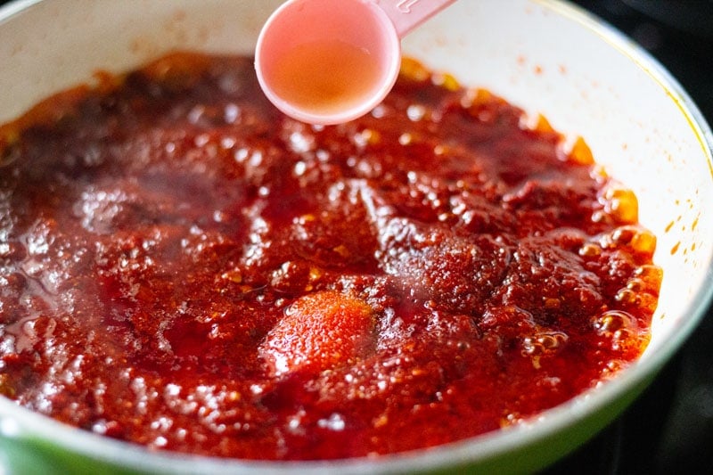 adding salt, seasonings to schezwan sauce