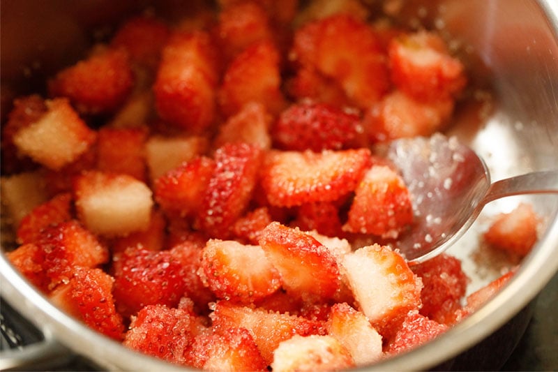 chopped strawberries tossed with sugar in saucepan