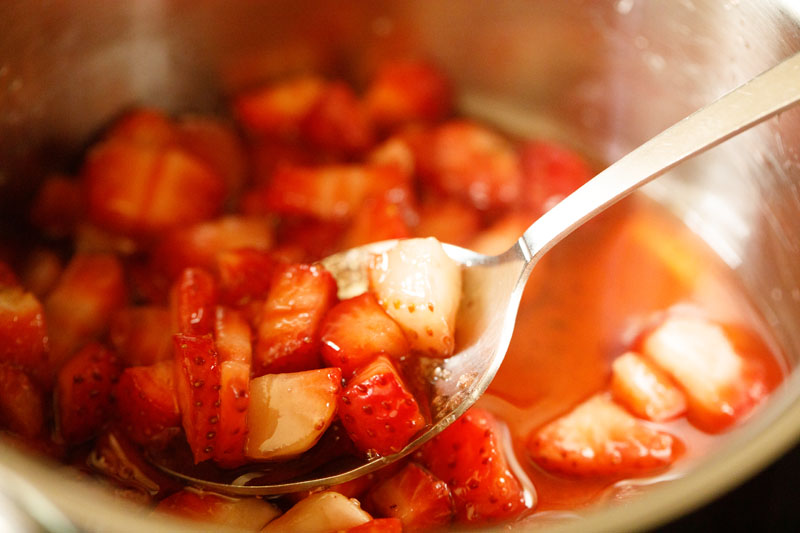 silver spoon illustrating properly macerated strawberries having natural juices that are released