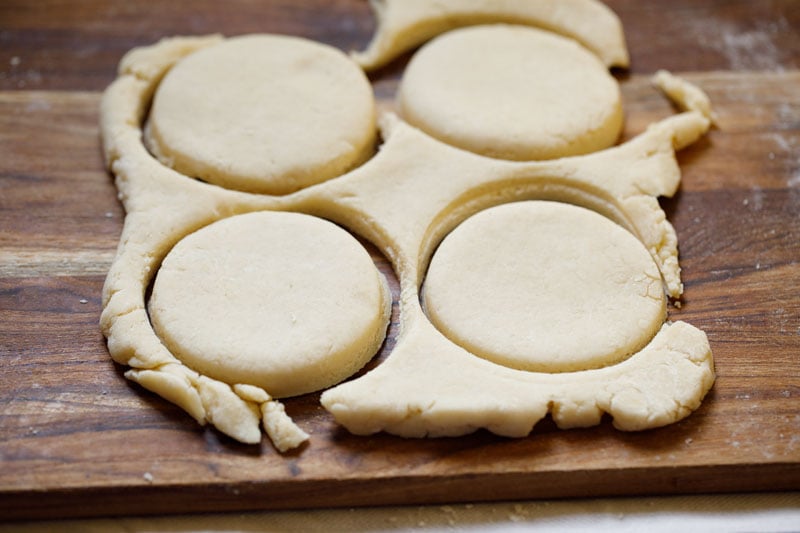 dough cut in neat circles using a cookie cutter on a wooden board