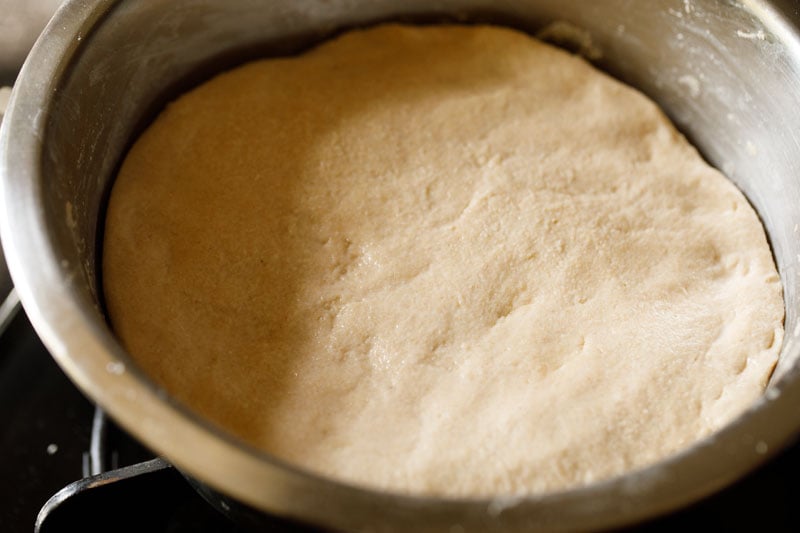 dough spread with water in bowl.