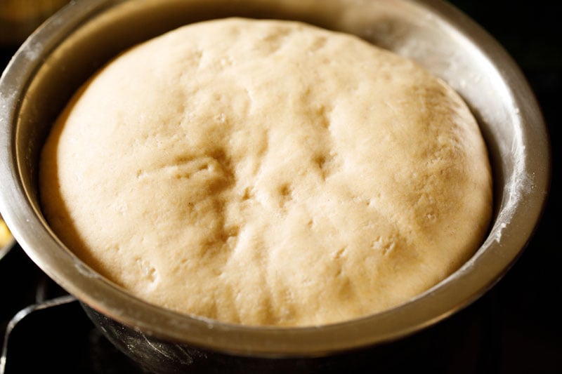 atta bread dough doubled in size in bowl.