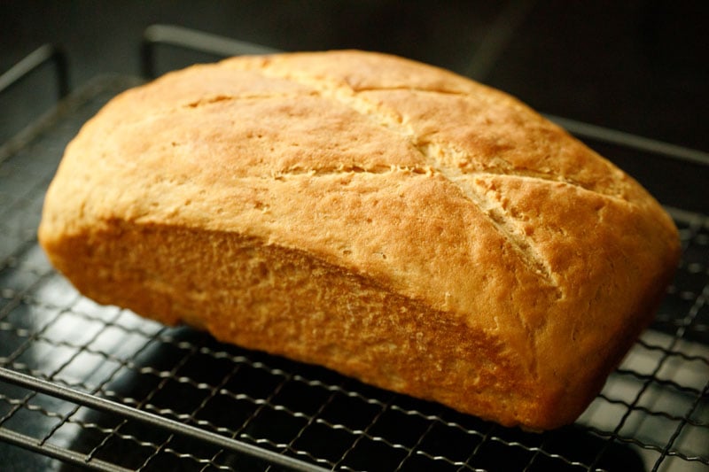 wholemeal bread loaf kept on wired tray. 