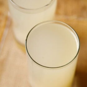 two collins glasses filled with lemon barley water