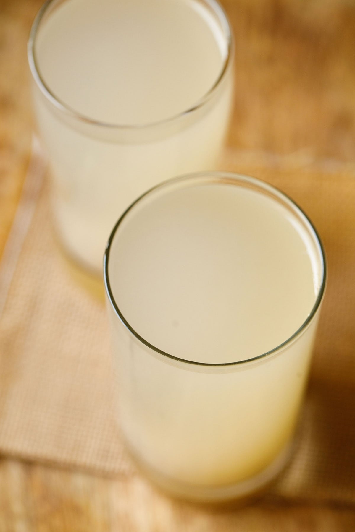 two collins glasses filled with lemon barley water