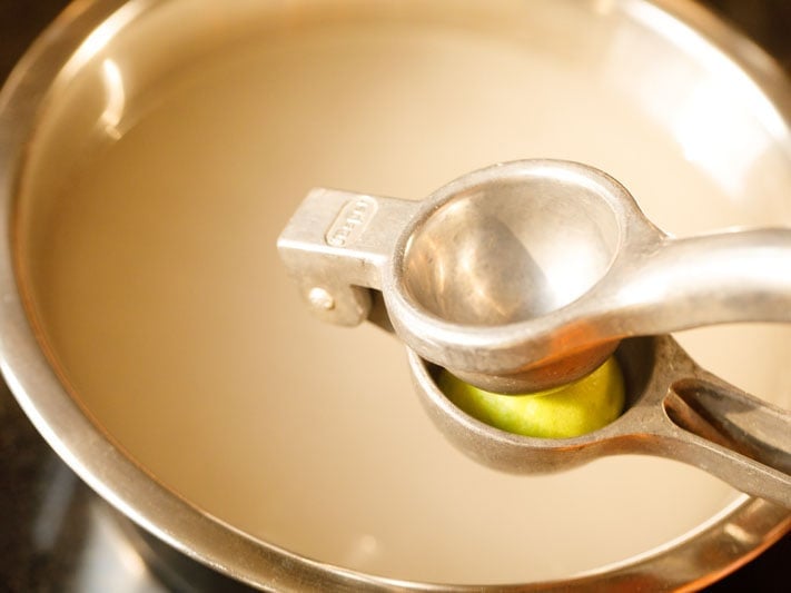 lemon squeezer above pot of barley water