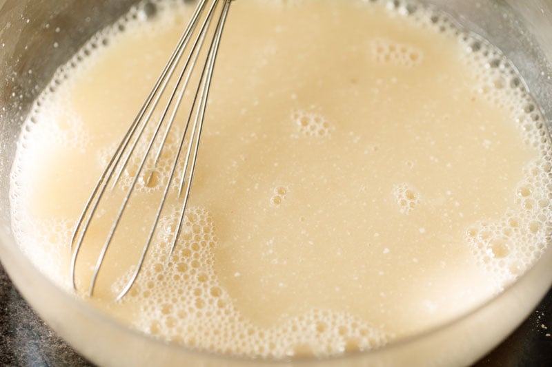 liquid ingredients being mixed with a wired whisk