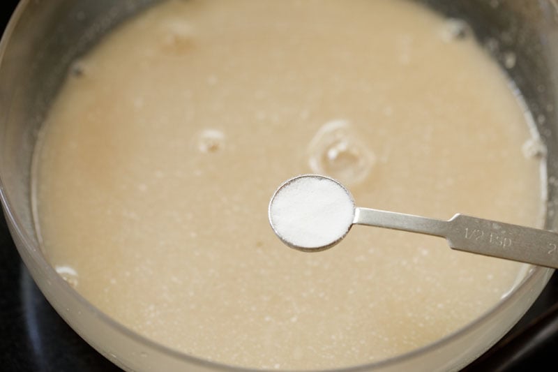 baking soda being added with a measuring spoon