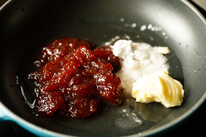 strawberry jam, butter, water and corn starch in a small black skillet