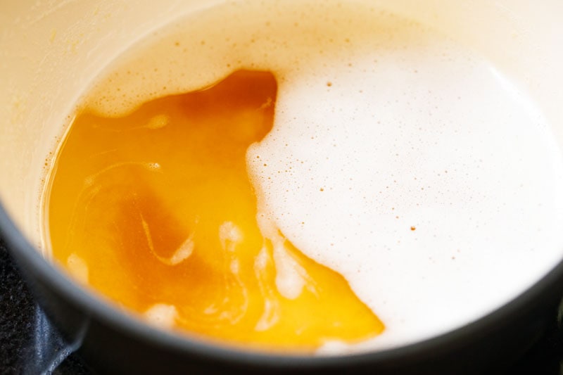 caramelized milk solids at the bottom of the pan of ghee