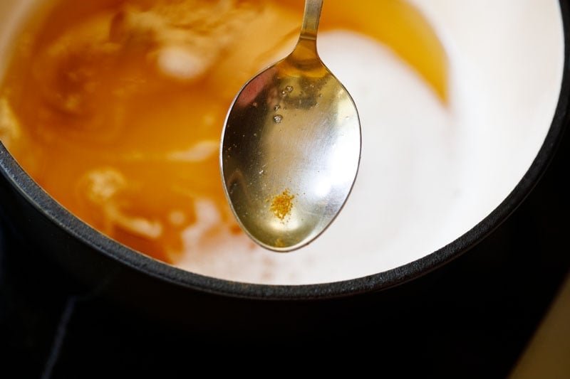 silver spoon showing golden colored caramelized milk solids