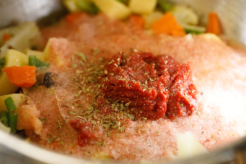 tomato puree, tomato paste and seasoning added to sautéed vegetables