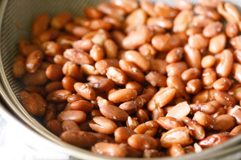 cooked beans in a strainer