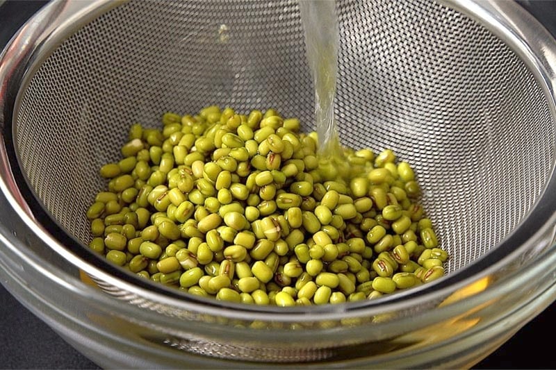 mung beans being rinsed in clean water