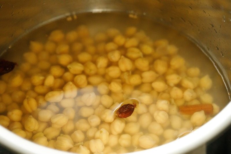 adding water to the pressure cooker. 