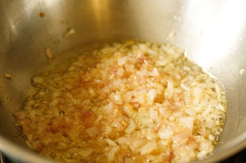 sautéing the onions in the pan. 