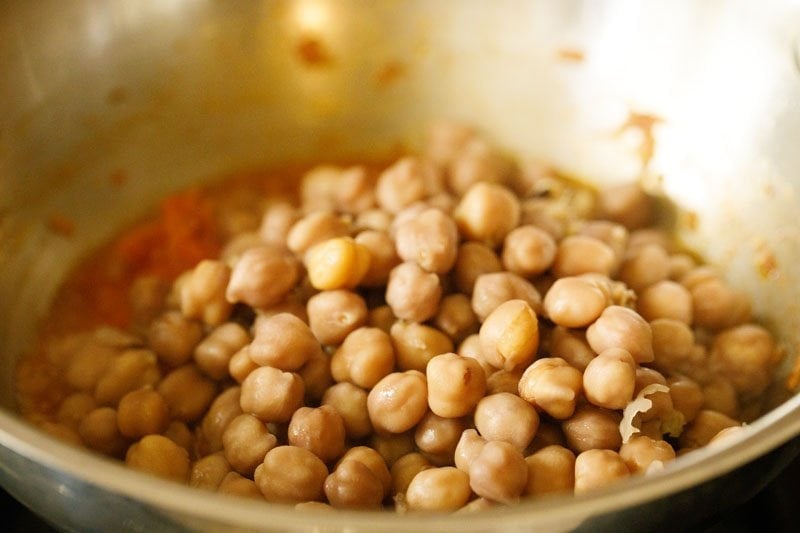 cooked chickpeas added to the onion-tomato mixture in pan. 