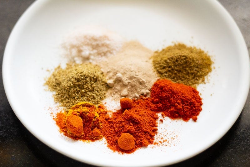 ground spices on a white plate