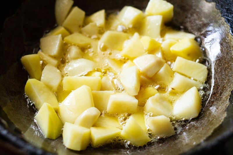 potatoes getting sautéed in oil