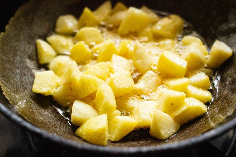 potatoes with light golden edges in wok
