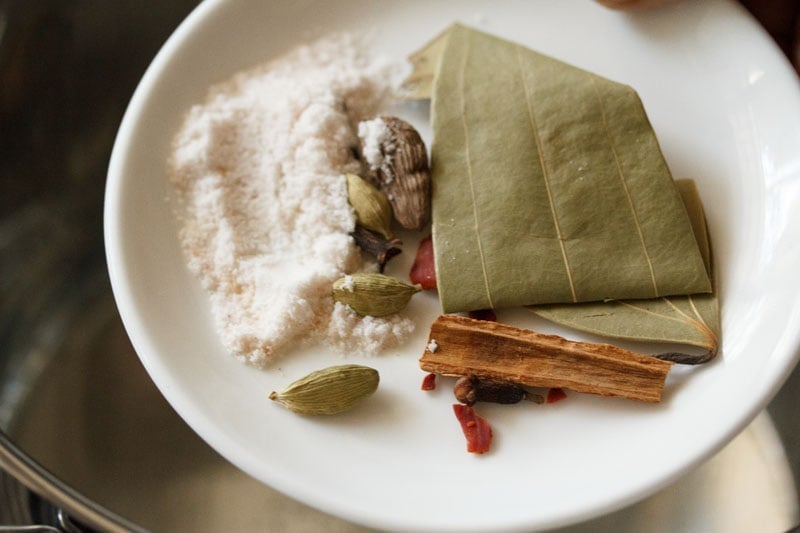 Top shot of spices on white plate for veg biryani recipe