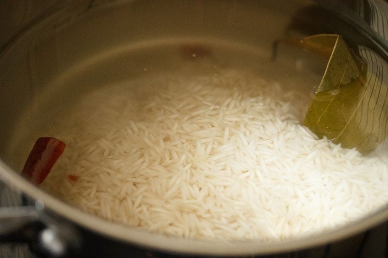 Top shot of rice cooking in pot for veg biryani recipe