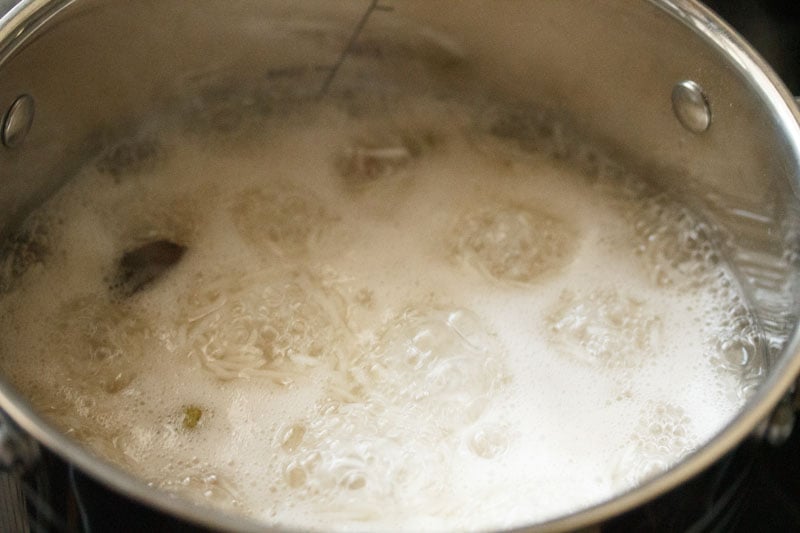 Top shot of rice boiling in pot