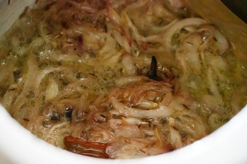 onions being sautéed for biryani