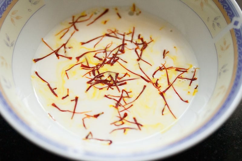 Top shot of saffron strands in milk in bowl