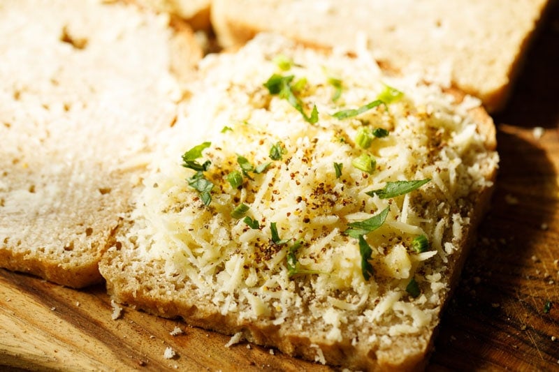 cheese topped with chopped basil and celery