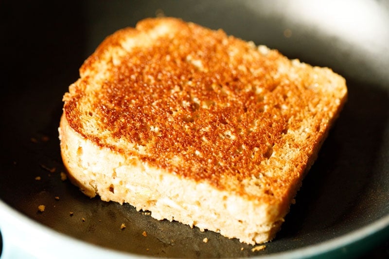 cheese sandwich flipped and crusty golden toast visible on top side